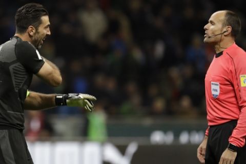 Italy goalkeeper Gianluigi Buffon, left, complains to Referee Antonio Mateu Lahoz of Spain during the World Cup qualifying play-off second leg soccer match between Italy and Sweden, at the Milan San Siro stadium, Italy, Monday, Nov. 13, 2017. (AP Photo/Luca Bruno)