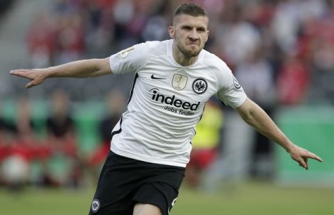 Frankfurt's Ante Rebic celebrates after scoring his side's opening goal challenge for the ball during the German soccer cup final match between FC Bayern Munich and Eintracht Frankfurt in Berlin, Germany, Saturday, May 19, 2018. (AP Photo/Michael Sohn)