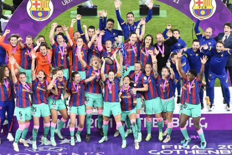 Barcelona players hold the trophy aloft after the UEFA Women's Champions League final soccer match between Chelsea FC and FC Barcelona in Gothenburg, Sweden, Sunday, May 16, 2021. Barcelona won 4-0. (AP Photo/Martin Meissner)