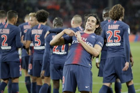 PSG's Edinson Cavani celebrates after scoring his side's third goal during the French League One soccer match between Paris-Saint-Germain and Reims at the Parc des Princes stadium in Paris, France, Wednesday, Sept. 26, 2018. (AP Photo/Michel Euler)