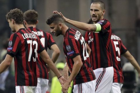 AC Milan's Mateo Musacchio, 2nd right, is congratulated by Leonardo Bonucci after scoring his side's second goal, during the Europa League group D soccer match between AC Milan and Rijeka, at the Milan San Siro Stadium, Italy, Thursday, Sept. 28, 2017. (AP Photo/Luca Bruno)
