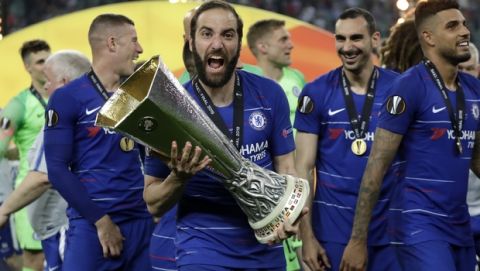 Chelsea's Gonzalo Higuain celebrates with the trophy after winning the Europa League Final soccer match between Arsenal and Chelsea at the Olympic stadium in Baku, Azerbaijan, Wednesday, May 29, 2019. Chelsea won 4-1. (AP Photo/Luca Bruno)