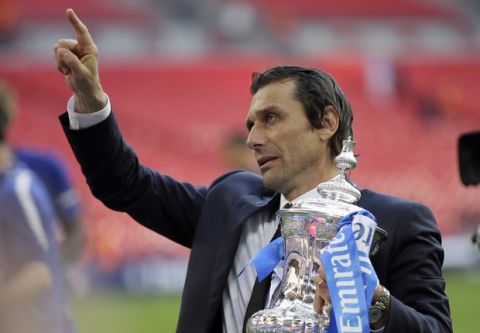 Chelsea head coach Antonio Conte holds the trophy after winning the English FA Cup final soccer match between Chelsea and Manchester United at Wembley stadium in London, Saturday, May 19, 2018. Chelsea defeated Manchester United 1-0. (AP Photo/Tim Ireland)