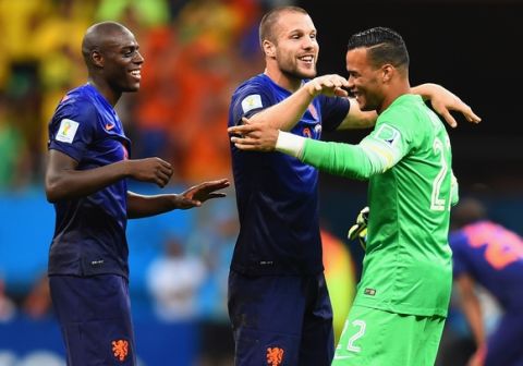 BRASILIA, DF - JULY 12: (L-R) Bruno Martins Indi, Ron Vlaar and Michel Vorm of the Netherlands celebrate after defeating Brazil 3-0 during the 2014 FIFA World Cup Brazil Third Place Playoff match between Brazil and the Netherlands at Estadio Nacional on July 12, 2014 in Brasilia, Brazil.  (Photo by Buda Mendes/Getty Images)