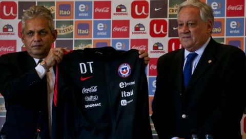 Arturo Salah, head of Chile's National Soccer Association, stands by as Reinaldo Rueda, from Colombia, holds up his Technical Directory jersey and is presented as the new head coach of Chile's national soccer team, during a press conference in Santiago, Chile, Friday, Jan. 19, 2018. (AP Photo/Esteban Felix)