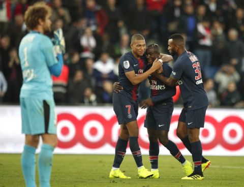 PSG's Diaby, centre, celebrates with his teammate PSG's Kylian Mbappe and PSG's Kevin Rimane after scoring his side's fifth goal during the French League One soccer match between Paris-Saint-Germain and Amiens at the Parc des Princes stadium in Paris, France, Saturday, Oct. 20, 2018. (AP Photo/Francois Mori)