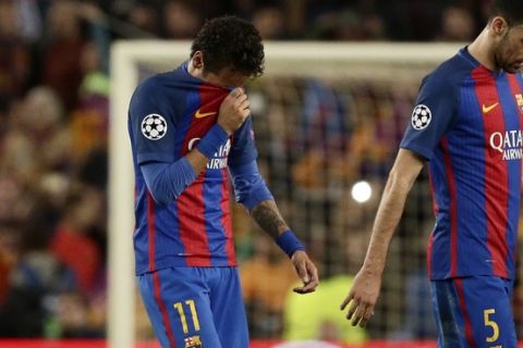 Barcelona's Jordi Alba, Neymar and Sergio Busquets, from left to right, leave the pitch at the end of the Champions League quarterfinal second leg soccer match between Barcelona and Juventus at Camp Nou stadium in Barcelona, Spain, Wednesday, April 19, 2017. The game ended in a goal less draw and Juventus advances after their first leg win. (AP Photo/Emilio Morenatti)