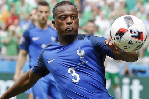 France's Patrice Evra eyes the ball during the Euro 2016 round of 16 soccer match between France and Ireland, at the Grand Stade in Decines-­Charpieu, near Lyon, France, Sunday, June 26, 2016. (AP Photo/Laurent Cipriani)