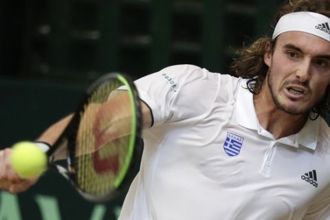 Stefanos Tsitsipas of Greece returns the ball to Alberto Lim of the Philippines during their Davis Cup World Group II play-offs first round singles match in Manila, Philippines on Friday, March 6, 2020. Tsitsipas won 6-2, 6-1. (AP Photo/Aaron Favila)