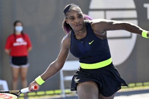 Serena Williams returns a shot to Shelby Rogers during action in their WTA tennis tournament match in Nicholasville, Ky., Friday, Aug. 14, 2020. (AP Photo/Timothy D. Easley)