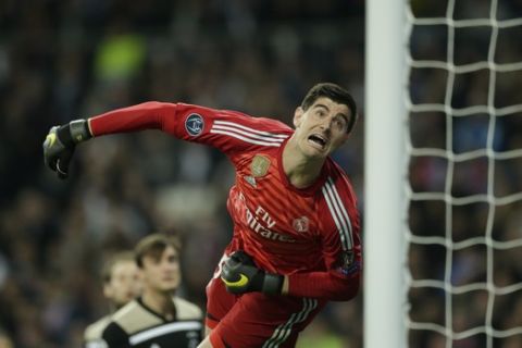Real goalkeeper Thibaut Courtois looks the ball as Ajax's Lasse Schone scores his side's fourth goal during the Champions League round of 16 second leg soccer match between Real Madrid and Ajax at the Santiago Bernabeu stadium in Madrid, Tuesday, March 5, 2019. (AP Photo/Bernat Armangue)