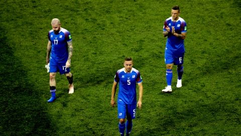 From left: Iceland's Aron Gunnarsson, Iceland's Sverrir Ingason and Iceland's Ragnar Sigurdsson greet supporters at the end of the group D match between Nigeria and Iceland at the 2018 soccer World Cup in the Volgograd Arena in Volgograd, Russia, Friday, June 22, 2018. (AP Photo/Themba Hadebe)