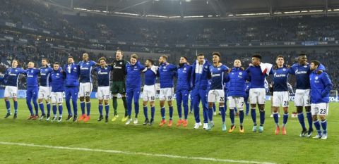 Schalke's team celebrates after the German Bundesliga soccer match between FC Schalke 04 and Hamburg SV in Gelsenkirchen, Germany, Sunday Nov. 19, 2017. Schalke defeated Hamburg with 2-0 and is now on the second place of the table behind Bayern. (AP Photo/Martin Meissner)