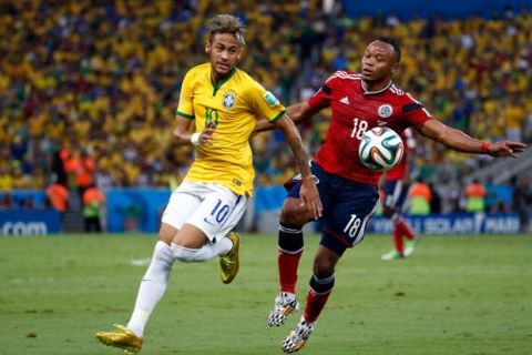 FORTALEZA, BRAZIL - JULY 04: Neymar of Brazil competes for the ball with Juan Camilo Zuniga of Colombia during the 2014 FIFA World Cup Brazil Quarter Final match between Brazil and Colombia at Castelao on July 4, 2014 in Fortaleza, Brazil.  (Photo by Gabriel Rossi/Getty Images)