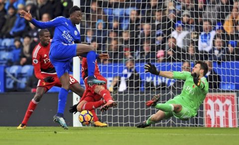 Leicester City's Wilfred Ndidi, left, takes a shot at goal from close range during the English Premier League match between Leicester City and Watford, at the King Power Stadium, in Leicester, England, Saturday, Jan. 20, 2018. (Mike Egerton/PA via AP)