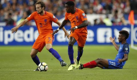 France's Kingsley Coman , right, watches Netherlands' Daley Blind, left, and Netherlands' Quincy Promes during the World Cup Group A qualifying soccer match between France and The Netherlands at the Stade de France stadium in Saint-Denis, outside Paris, Thursday, Aug.31, 2017. (AP Photo/Christophe Ena)