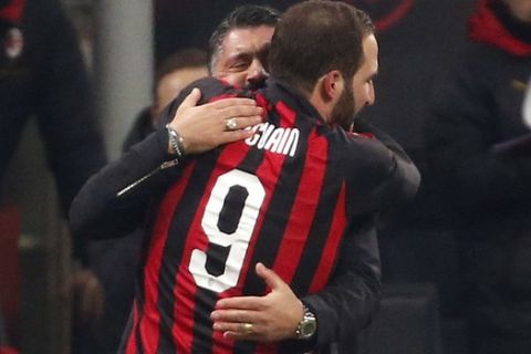 AC Milan's Gonzalo Higuain, right, celebrates with AC Milan coach Gennaro Gattuso after scoring his side's second goal during a Serie A soccer match between AC Milan and Spal, at the San Siro stadium, Saturday, Dec. 29, 2018. (AP Photo/Antonio Calanni)