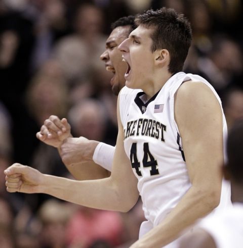 Wake Forest's Konstantinos Mitoglou (44) and Devin Thomas, back, celebrate after Mitoglou's 3-point basket against Pittsburgh during the second half of an NCAA college basketball game in Winston-Salem, N.C., Sunday, March 1, 2015. Wake Forest won 69-66. (AP Photo/Chuck Burton)