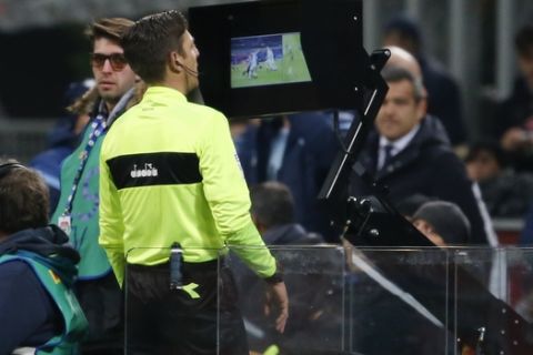 Referee Gianluca Rocchi checks the VAR during the Serie A soccer match between Inter Milan and Lazio, at the Milan's San Siro stadium, Italy, Saturday, Dec. 30, 2017. (AP Photo/Antonio Calanni)