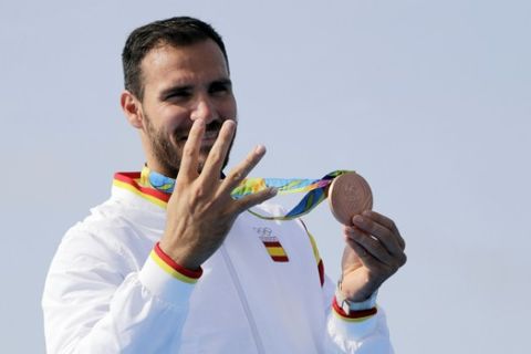 FILE - In this Saturday, Aug. 20, 2016 file photo, Spain's Saul Craviotto celebrates his bronze medal in the men's kayak single 200m final during the 2016 Summer Olympics in Rio de Janeiro, Brazil. Catalonia's audacious attempt to secede from the rest of Spain represents a threat to one of the world's sporting powers. Kayak gold medalist Saul Craviotto is in the unique position of being a top athlete as well as an officer in Spain's National Police stationed in his hometown of Lleida in northeastern Catalonia.(AP Photo/Matt York, file)