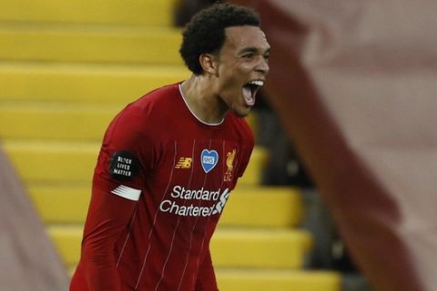 Liverpool's Trent Alexander-Arnold celebrates after scoring his side s 2nd goal of the game from a free kick during the English Premier League soccer match between Liverpool and Chelsea at Anfield Stadium in Liverpool, England, Wednesday, July 22, 2020. (Phil Noble/Pool via AP)