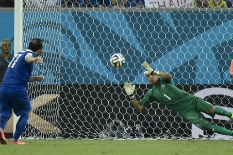 Costa Rica's goalkeeper Keylor Navas, right, makes a save on Greece's Fanis Gekas' penalty shot during a shootout after regulation time in the World Cup round of 16 soccer match between Costa Rica and Greece at the Arena Pernambuco in Recife, Brazil, Sunday, June 29, 2014. Costa Rica defeated Greece 5-3 in penalty shootouts after a 1-1 tie. (AP Photo/Martin Meissner)