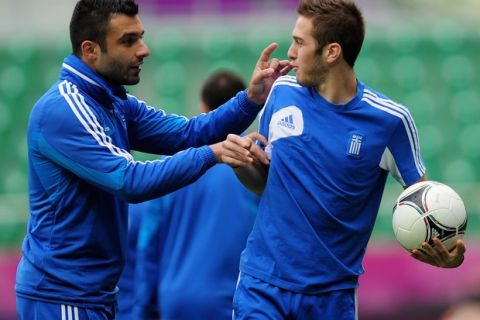 WROCLAW, POLAND - JUNE 11:  Giorgos Tzavellas of Greece flicks the ear of team mate Kostas Fortounis during a UEFA EURO 2012 training session at the Municipal Stadium on June 11, 2012 in Wroclaw, Poland.  (Photo by Jamie McDonald/Getty Images)