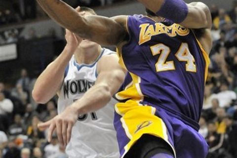 Los Angeles Lakers' Kobe Bryant drives for a layup as Minnesota Timberwolves' Darko Milicic, of Serbia, defends during the second half of an NBA basketball game Friday, Nov. 19, 2010, in Minneapolis. The Lakers won 112-95, with Bryant scoring 23 points. (AP Photo/Jim Mone)
