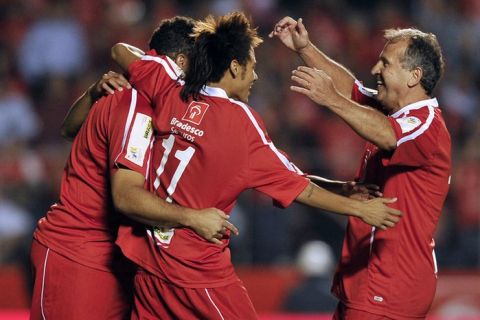 Brazilian former footballer Zico (R) celebrates with teammates Neymar (C) and Ronaldo (L) after scoring during a charity football match organized by former Brazilian national team player Zico, at Morumbi stadium in Sao Paulo, Brazil, on December 28, 2011. AFP PHOTO / Nelson ALMEIDA (Photo credit should read NELSON ALMEIDA/AFP/Getty Images)