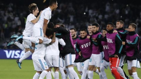 Real Madrid players celebrate after scoring the opening goal during the Club World Cup final soccer match between Real Madrid and Gremio at Zayed Sports City stadium in Abu Dhabi, United Arab Emirates, Saturday, Dec. 16, 2017. (AP Photo/Hassan Ammar)