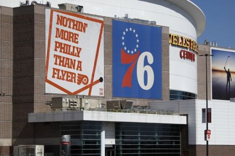 The Wells Fargo Center, home of the Philadelphia Flyers NHL hockey team and the Philadelphia 76ers NBA basketball team, is seen nearly empty, Saturday, March 14, 2020, in Philadelphia. All games at the Center have been postponed due to the COVID-19 pandemic. (AP Photo/Matt Slocum)