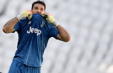 Juventus goalie Gianluigi Buffon reacts during the Serie A soccer match between Juventus and Torino, at the Allianz Stadium in Turin, Italy, Saturday, July 4, 2020. Juventus goalkeeper Gianluigi Buffon set an outright Serie A record on Saturday with his 648th appearance in Italys top flight. The Turin derby game against Torino moved the 42-year-old Buffon one ahead of AC Milan great Paolo Maldini, who set the record in 2009. (Fabio Ferrari/LaPresse via AP)