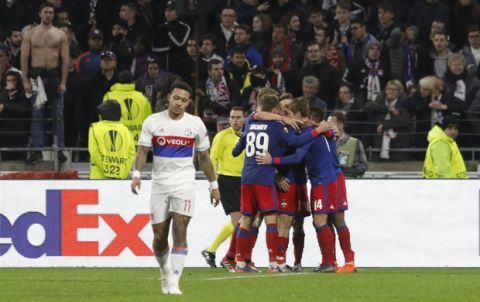 Lyon's Memphis Depay, left, reacts after CSKA's Ahmed Musa scored a goal and celebrate with teammates during the Europa League, round of 16 second leg soccer match between Lyon and CSKA Moscow in Decines, near Lyon, central France, Thursday March 15, 2018. (AP Photo/Laurent Cipriani)