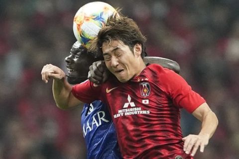 Al Hilal's Bafetimbi Gomis, left and Urawa Reds' Takahiro Sekine vie for the ball during the second leg of the AFC Champions League final soccer match between Urawa Reds and Al Hilal in Saitama, near Tokyo, Sunday, Nov. 24, 2019. (AP Photo/Christopher Jue)