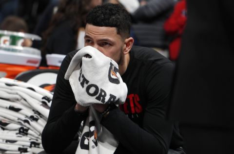 Houston Rockets guard Austin Rivers sits on the bench after word of the death of former NBA star Kobe Bryant before an NBA basketball game against the Denver Nuggets, Sunday, Jan. 26, 2020, in Denver. Bryant died in a California helicopter crash Sunday. (AP Photo/David Zalubowski)