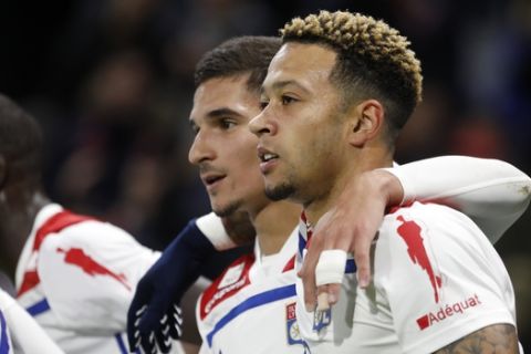 Lyon's Houssem Aouar, left, celebrates with Memphis Depay, right, after he scored a goal against Bordeaux during their French League One soccer match in Decines, near Lyon, central France, Saturday, Nov. 3, 2018. (AP Photo/Laurent Cipriani)