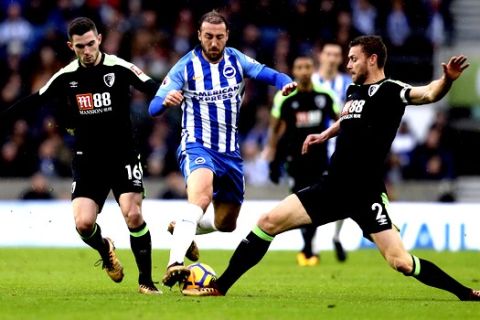 Brighton & Hove Albion's Glenn Murray battles for the ball with AFC Bournemouth's Simon Francis, right, and Lewis Cook during the English Premier League soccer match at the AMEX Stadium, Brighton, Monday Jan. 1, 2018. (Adam Davy/PA via AP)