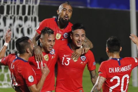 Chile's Erick Pulgar, second right, celebrates scoring his side's opening goal with teammates during a Copa America Group C soccer match at the Morumbi stadium in Sao Paulo, Brazil, Monday, June 17, 2019. (AP Photo/Nelson Antoine)