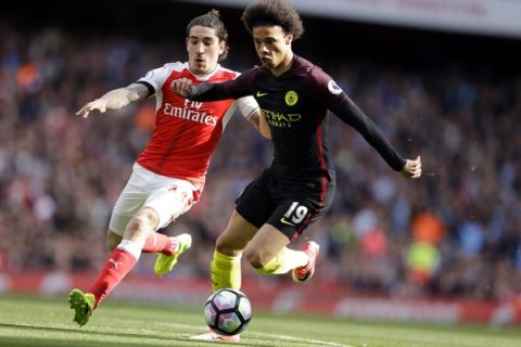 Manchester City's Leroy Sane, right, runs with the ball away from Arsenal's Hector Bellerin to score the opening goal during the English Premier League soccer match between Arsenal and Manchester City at the Emirates stadium in London, Sunday, April 2, 2017. (AP Photo/Alastair Grant)