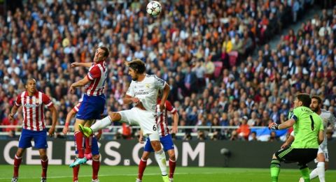 LISBON, PORTUGAL - MAY 24:  Diego Godin of Club Atletico de Madrid heads in the first goal during the UEFA Champions League Final between Real Madrid and Atletico de Madrid at Estadio da Luz on May 24, 2014 in Lisbon, Portugal.  (Photo by Shaun Botterill/Getty Images)