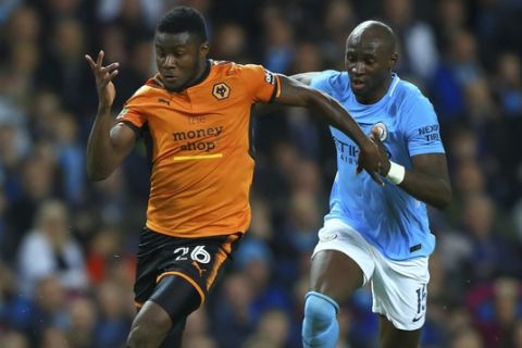 Wolverhampton Wanderers' Bright Enobakhare, left, and Manchester City's Eliaquim Mangala battle for the ball during the English League Cup soccer match between Manchester City and Wolverhampton Wanderers at the Etihad Stadium, Manchester, England, Tuesday, Oct. 24, 2017. (Tim Goode/PA via AP)