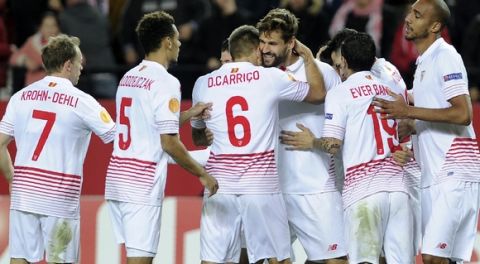 Sevilla's forward Fernando Llorente (4th L) celebrates his second goal with teammates during the UEFA Europa League Round of 32 first leg football match Sevilla FC vs Molde FK at the Ramon Sanchez Pizjuan stadium in Sevilla on February 18, 2016. / AFP / CRISTINA QUICLER        (Photo credit should read CRISTINA QUICLER/AFP/Getty Images)