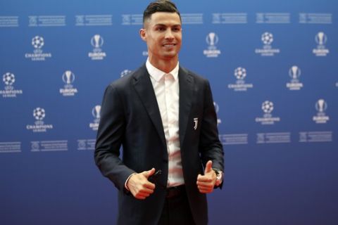Juventus' soccer player Cristiano Ronaldo poses to the photographers before the UEFA Champions League group stage draw at the Grimaldi Forum, in Monaco, Thursday, Aug. 29, 2019. (AP Photo/Daniel Cole)