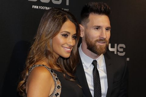 Soccer player Lionel Messi and wife Antonella arrive to attend The Best FIFA 2017 Awards at the Palladium Theatre in London, Monday, Oct. 23, 2017. (AP Photo/Alastair Grant)