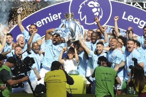 FILE - In this Sunday, May 6, 2018 file photo, Manchester City players lift the English Premier League trophy after the soccer match between Manchester City and Huddersfield Town at Etihad stadium in Manchester, England. The Premier League fixtures for the 2018-19 season were published on Thursday June 14, 2018 and Unai Emery has been handed the toughest possible start to his tenure at Arsenal: a match against English Premier League champion Manchester City. (AP Photo/Rui Vieira, file)