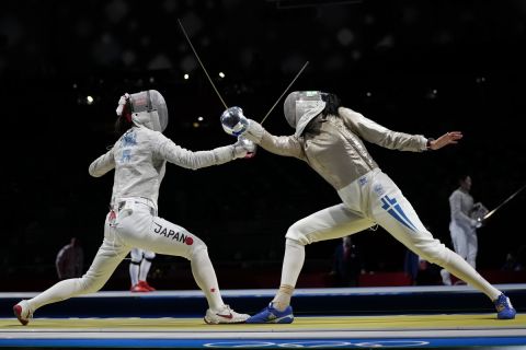 Theodora Gkountoura of Greece, right, and Misaki Emura of Japan compete in the women's individual round of 32 Sabre competition at the 2020 Summer Olympics, Monday, July 26, 2021, in Chiba, Japan. (AP Photo/Hassan Ammar)