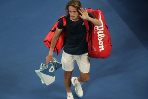 Greece's Stefanos Tsitsipas waves as he leaves Rod Laver Arena after losing his semifinal to Spain's Rafael Nadal at the Australian Open tennis championships in Melbourne, Australia, Thursday, Jan. 24, 2019. (AP Photo/Kin Cheung)