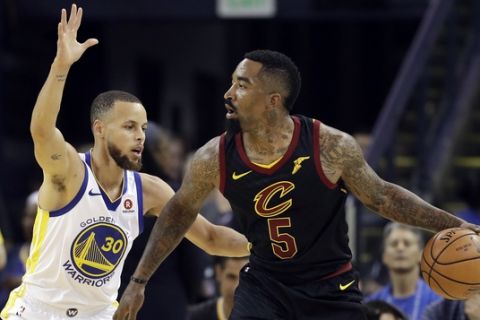 Cleveland Cavaliers guard J.R. Smith (5) is defended by Golden State Warriors guard Stephen Curry (30) during the first half of Game 1 of basketball's NBA Finals in Oakland, Calif., Thursday, May 31, 2018. (AP Photo/Marcio Jose Sanchez)