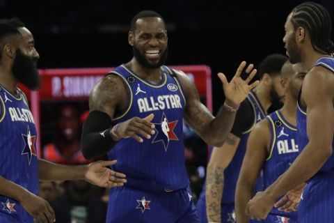LeBron James of the Los Angeles Lakers celebrates with James Harden of the Houston Rockets and Kawhi Leonard of the Los Angeles Clippers during the second half of the NBA All-Star basketball game Sunday, Feb. 16, 2020, in Chicago. (AP Photo/Nam Huh)