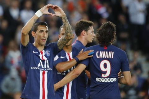 PSG's Angel Di Maria celebrates with his teammates after scoring his side's third goal during the French League One soccer match between Paris Saint Germain and Nimes at the Parc des Princes Stadium in Paris, Sunday, Aug. 11, 2019. (AP Photo/Francois Mori)